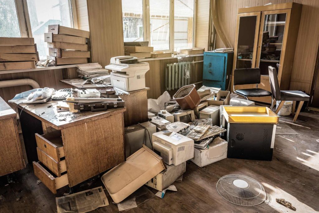 Abandoned office space filled with broken equipment.